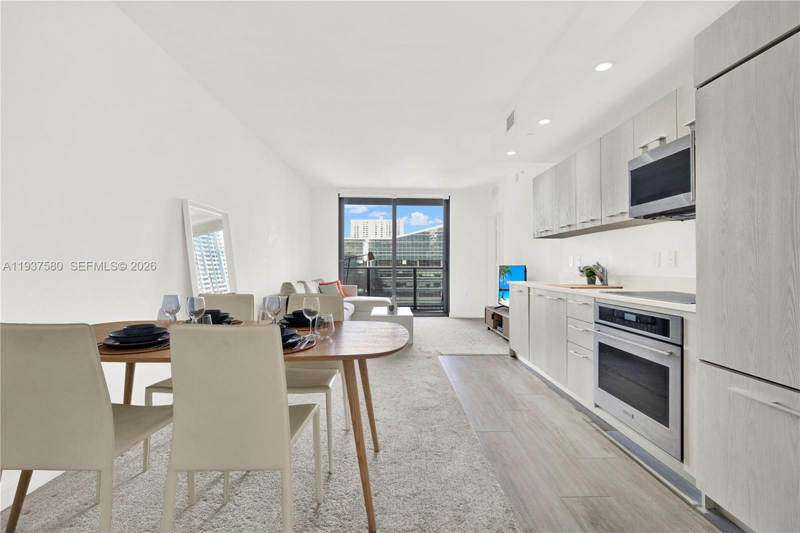 45 Southwest 9th Street, Unit 1609 Miami, FL 33130 - Photo 4 of 39 a living room with furniture a large window and a fireplace