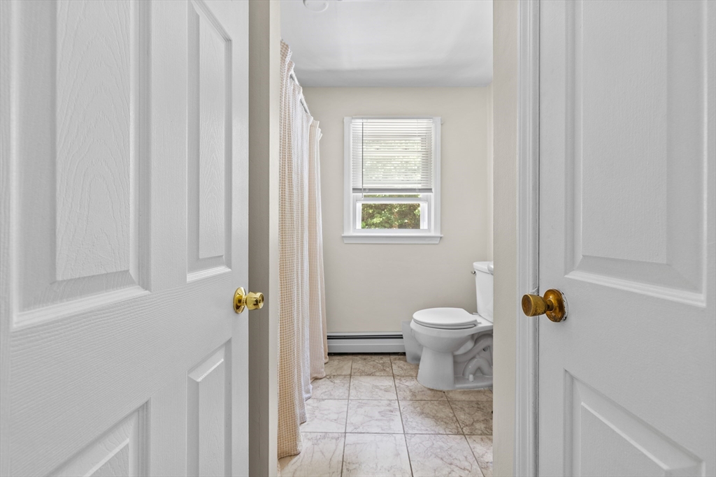 450 Skunknet Road Barnstable, MA 02632 - Photo 11 of 42 a bathroom with a toilet and a window