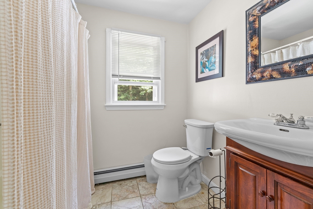 450 Skunknet Road Barnstable, MA 02632 - Photo 12 of 42 a bathroom with a sink a toilet and vanity