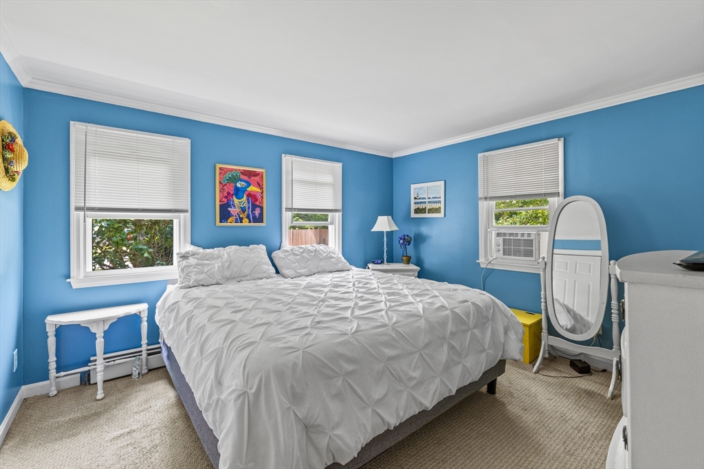 450 Skunknet Road Barnstable, MA 02632 - Photo 13 of 42 a bedroom with a bed a dresser and painting