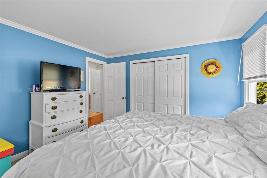 450 Skunknet Road Barnstable, MA 02632 - Photo 14 of 42 a bedroom with a bed and flat screen tv