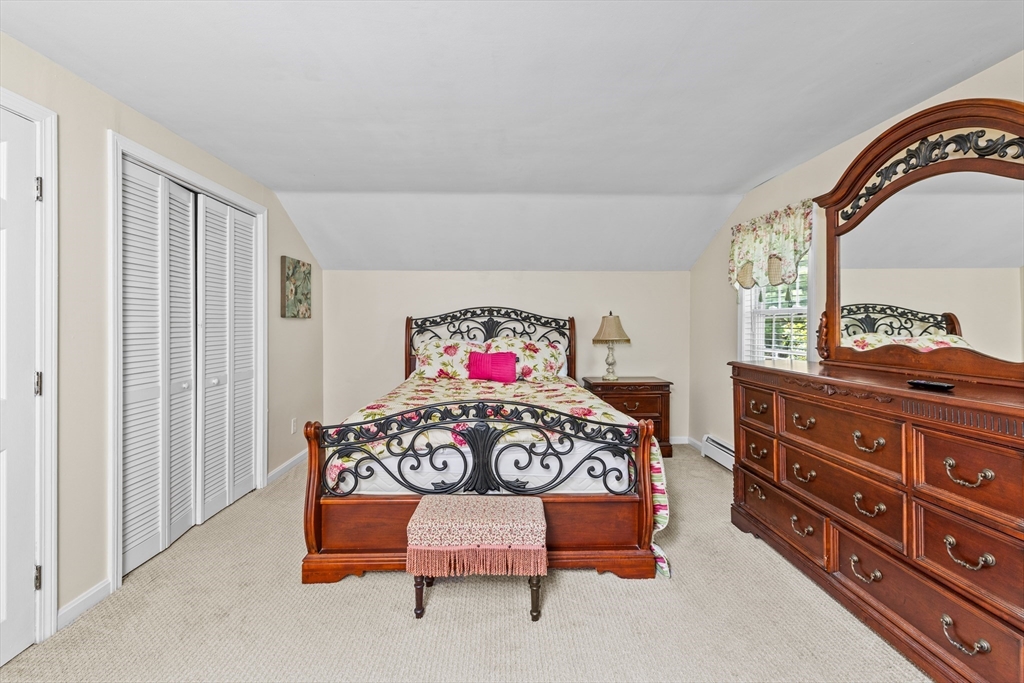 450 Skunknet Road Barnstable, MA 02632 - Photo 16 of 42 a bedroom with a bed and a dresser in it