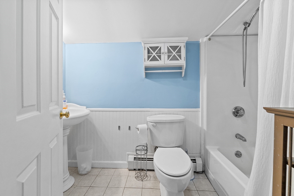 450 Skunknet Road Barnstable, MA 02632 - Photo 18 of 42 a white toilet sitting next to a bathroom sink and tub