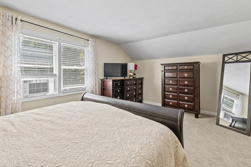 450 Skunknet Road Barnstable, MA 02632 - Photo 20 of 42 a bedroom with a large bed and a flat tv screen