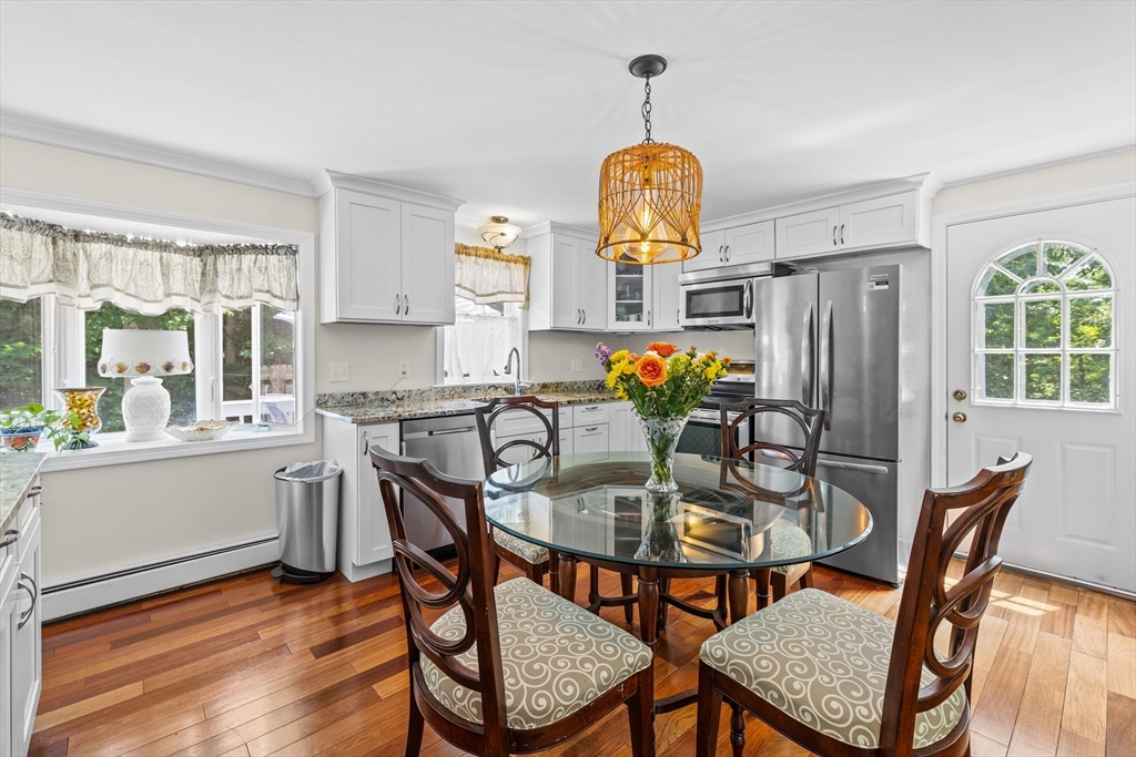 450 Skunknet Road Barnstable, MA 02632 - Photo 2 of 42 a view of a dining room with furniture window and wooden floor