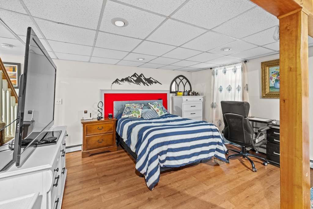 450 Skunknet Road Barnstable, MA 02632 - Photo 22 of 42 a bedroom with a bed and a flat screen tv