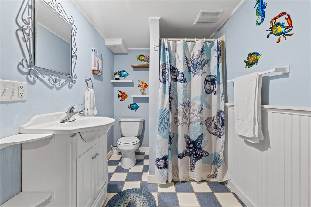 450 Skunknet Road Barnstable, MA 02632 - Photo 27 of 42 a bathroom with a sink toilet and shower