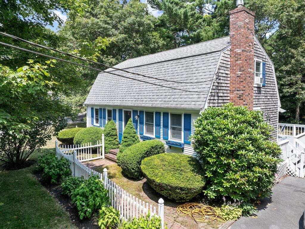 450 Skunknet Road Barnstable, MA 02632 - Photo 29 of 42 a view of a house with a yard and potted plants