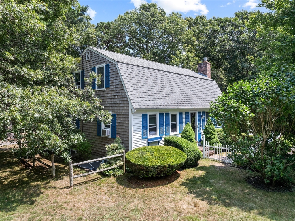 450 Skunknet Road Barnstable, MA 02632 - Photo 30 of 42 a view of a house with a yard and potted plants