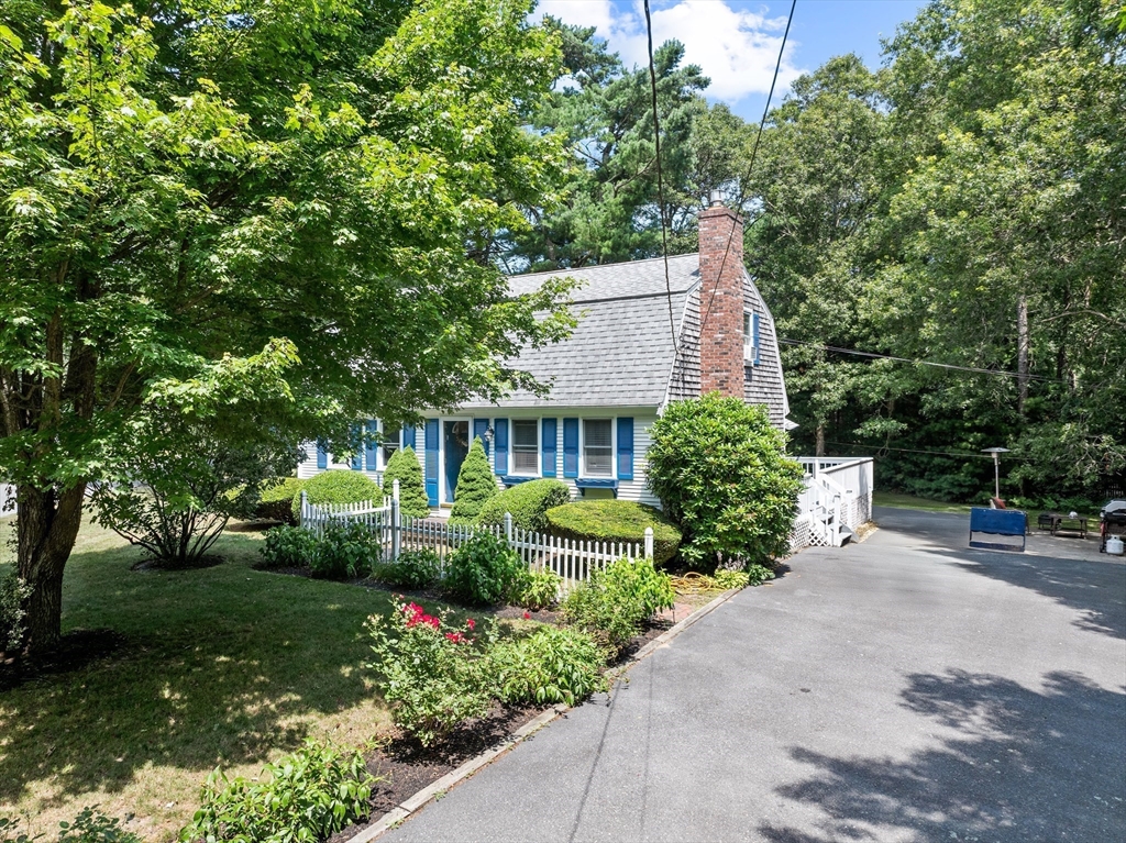 450 Skunknet Road Barnstable, MA 02632 - Photo 33 of 42 a view of a garden with potted plants and large trees
