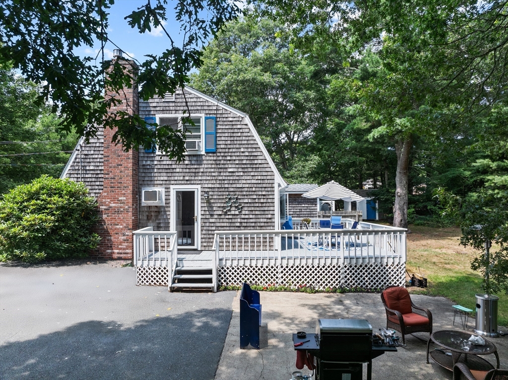 450 Skunknet Road Barnstable, MA 02632 - Photo 34 of 42 a roof deck with table and chairs and potted plants
