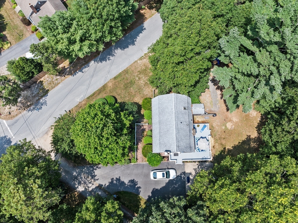 450 Skunknet Road Barnstable, MA 02632 - Photo 40 of 42 an aerial view of a house with a garden and trees