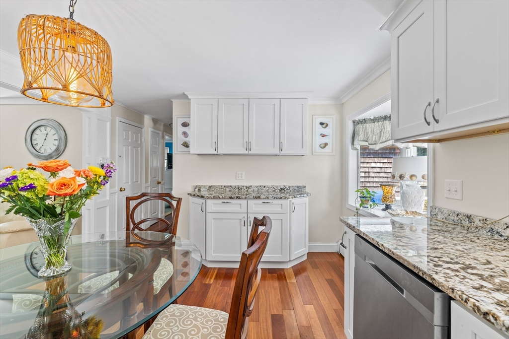 450 Skunknet Road Barnstable, MA 02632 - Photo 4 of 42 a kitchen with stainless steel appliances granite countertop a dining table cabinets stove and a sink