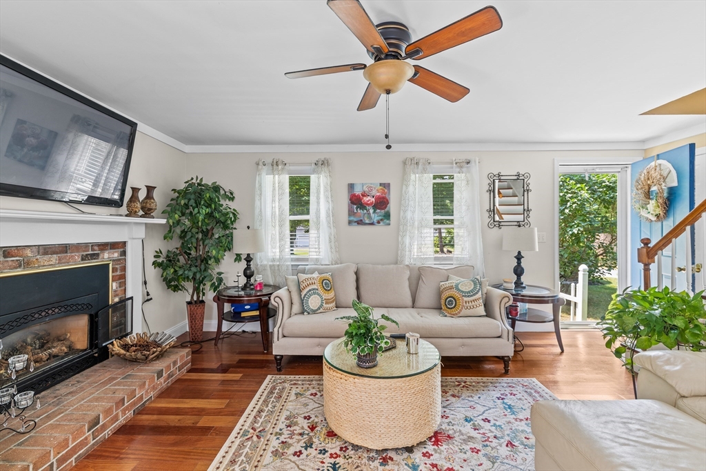 450 Skunknet Road Barnstable, MA 02632 - Photo 5 of 42 a living room with furniture a fireplace and a large window