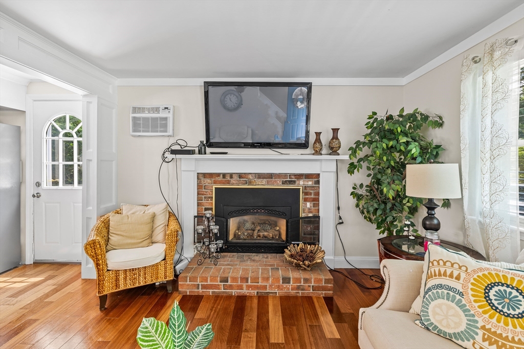 450 Skunknet Road Barnstable, MA 02632 - Photo 7 of 42 a living room with furniture and a fireplace