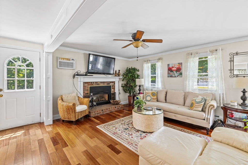 450 Skunknet Road Barnstable, MA 02632 - Photo 8 of 42 a living room with furniture a fireplace and a flat screen tv
