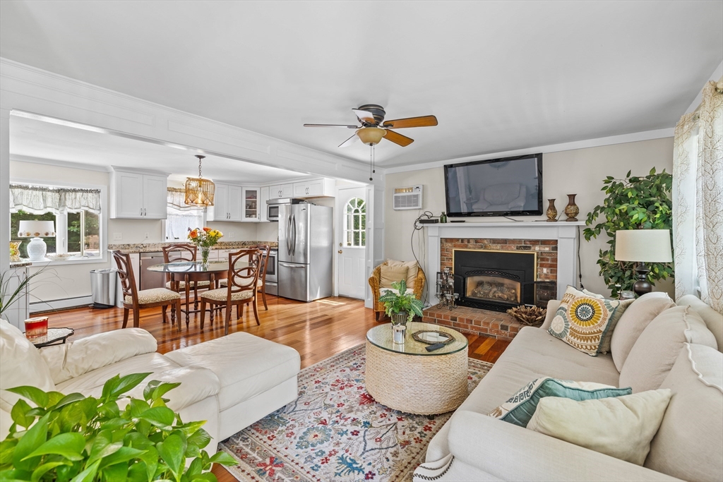 450 Skunknet Road Barnstable, MA 02632 - Photo 9 of 42 a living room with furniture and a fireplace
