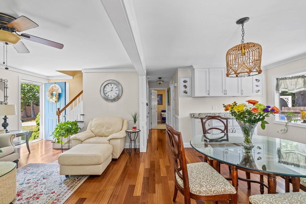 450 Skunknet Road Barnstable, MA 02632 - Photo 10 of 42 a living room with furniture a rug and a chandelier