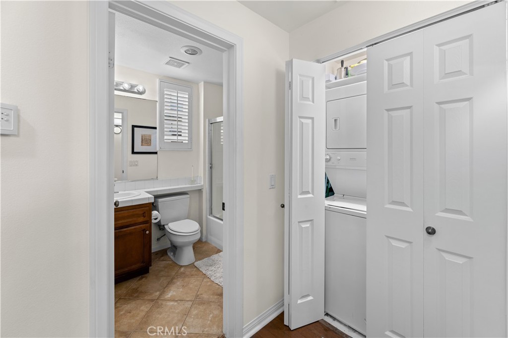 122 Jadestone Irvine, CA 92603 - Photo 12 of 20 a bathroom with a granite countertop toilet a sink and mirror