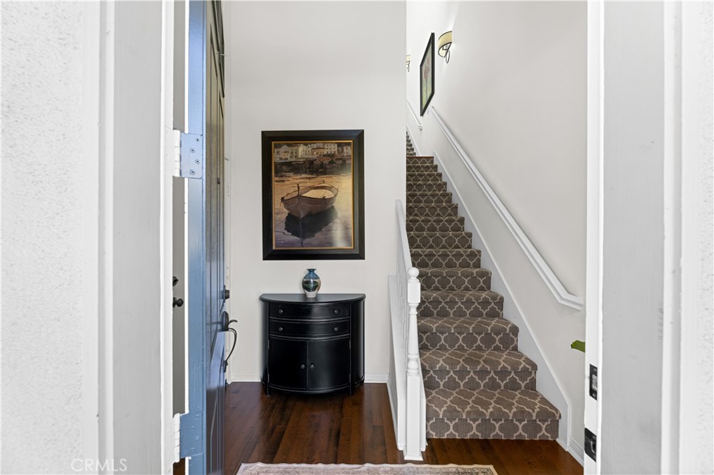 122 Jadestone Irvine, CA 92603 - Photo 2 of 20 a view of a hallway with wooden floor and staircase