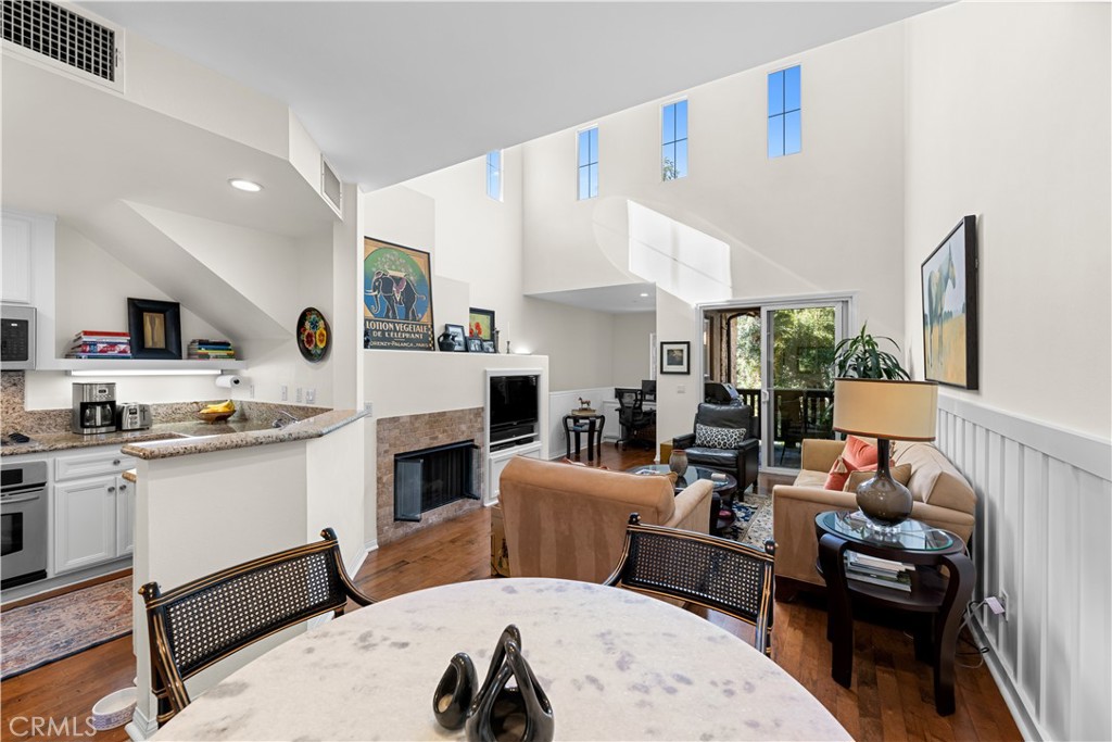 122 Jadestone Irvine, CA 92603 - Photo 6 of 20 a living room with furniture a fireplace and a flat screen tv