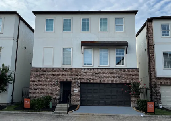 a front view of a house with garage
