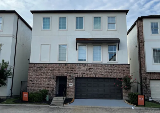 a front view of a house with garage