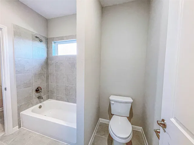 a bathroom with a toilet a sink and bathtub
