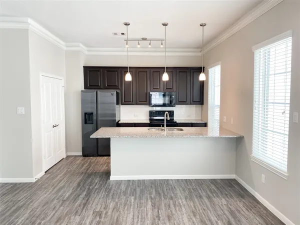 a view of kitchen with sink microwave refrigerator and outdoor view