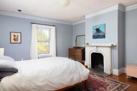 a bed room with a bed and a chair