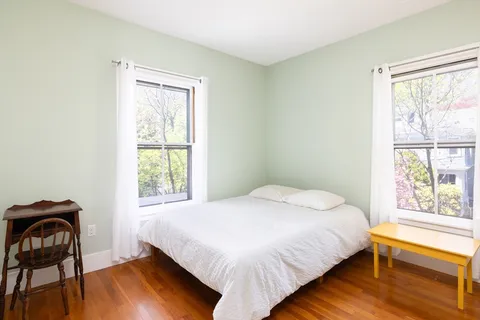 a bedroom with a bed and a window