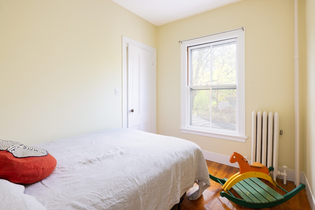 135 Langley Road Newton, MA 02459 - Photo 14 of 20 a bedroom with a bed and a window