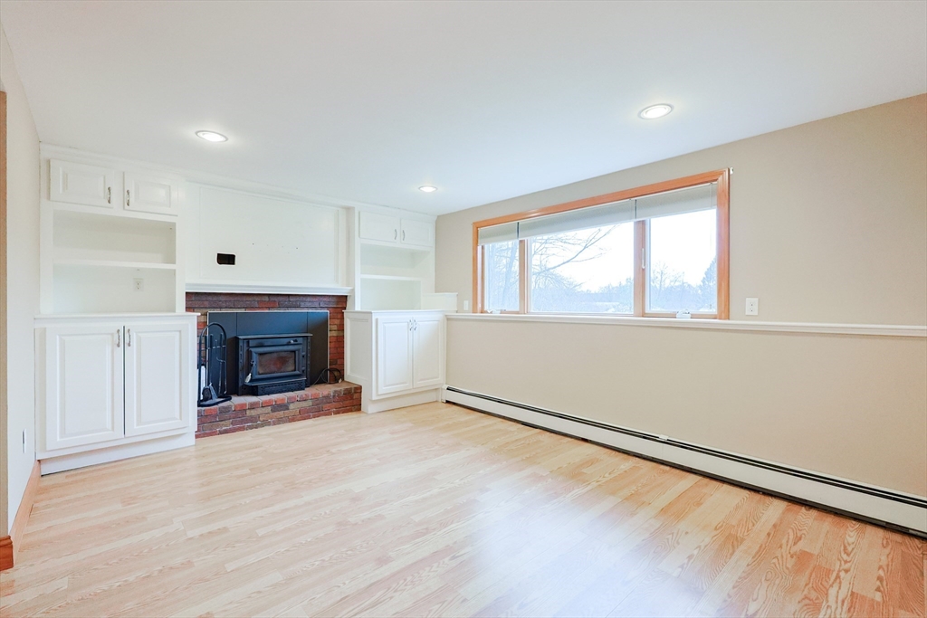 68 Greene Street, Unit A Hopedale, MA 01747 - Photo 12 of 26 a view of an empty room with a window and fireplace