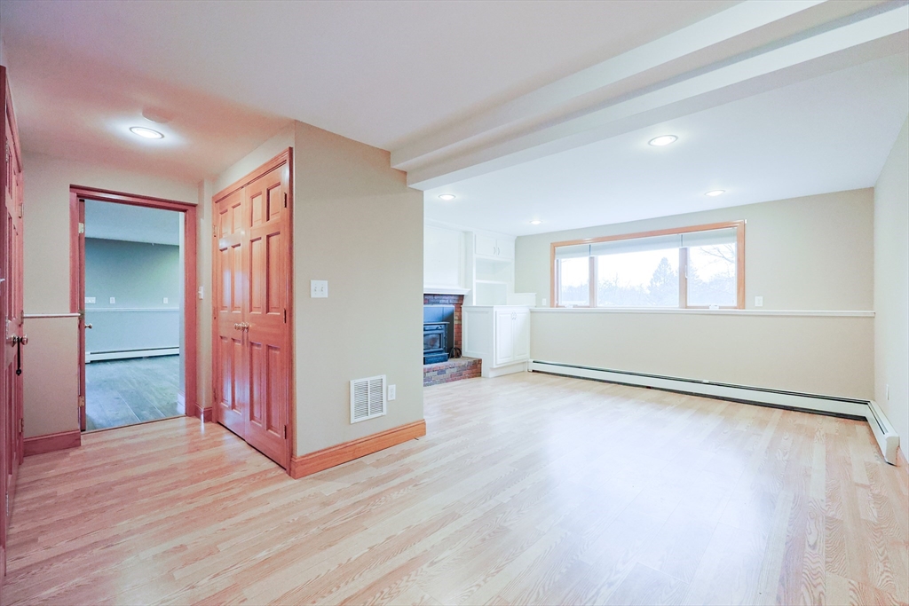 68 Greene Street, Unit A Hopedale, MA 01747 - Photo 15 of 26 an empty room with wooden floor and windows