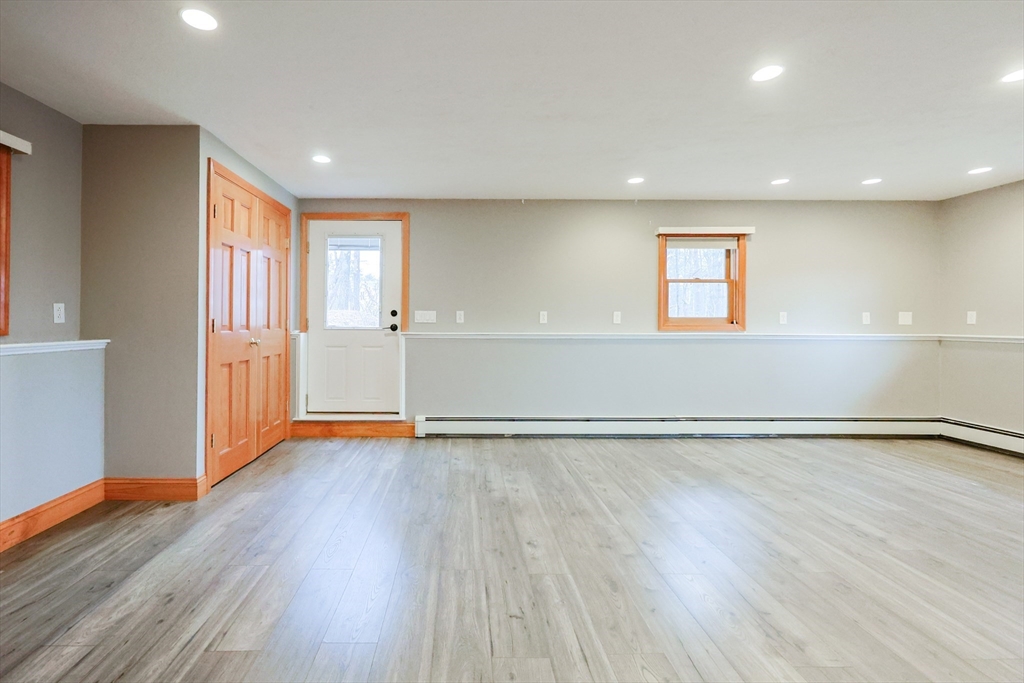 68 Greene Street, Unit A Hopedale, MA 01747 - Photo 16 of 26 a view of an empty room with wooden floor and a window