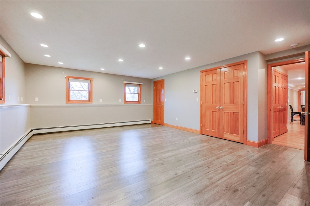 68 Greene Street, Unit A Hopedale, MA 01747 - Photo 17 of 26 a view of an empty room with wooden floor and a window