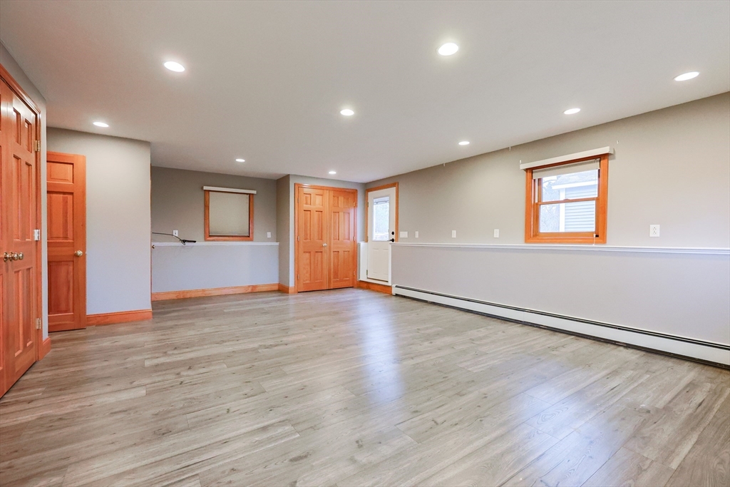 68 Greene Street, Unit A Hopedale, MA 01747 - Photo 18 of 26 an empty room with wooden floor and windows