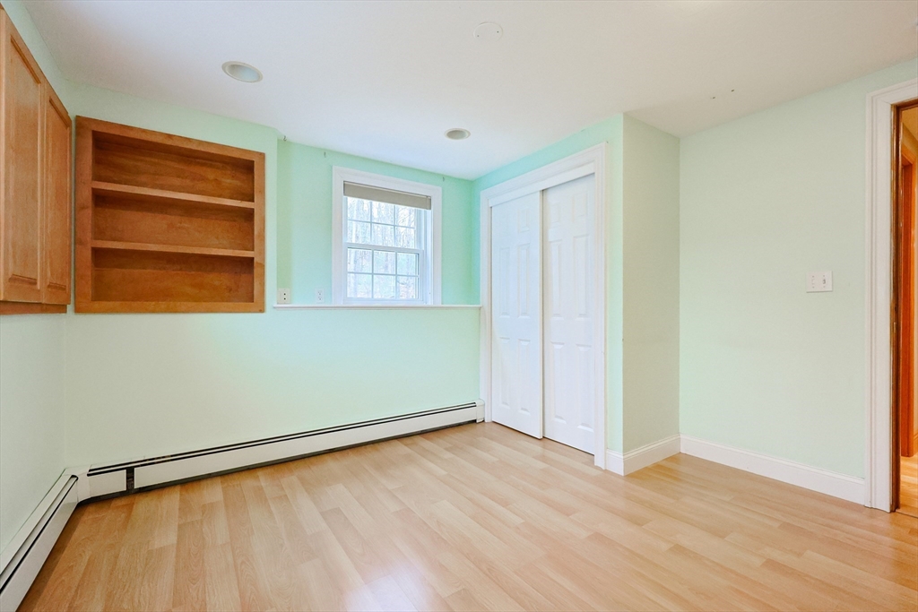 68 Greene Street, Unit A Hopedale, MA 01747 - Photo 20 of 26 an empty room with wooden floor closet and windows