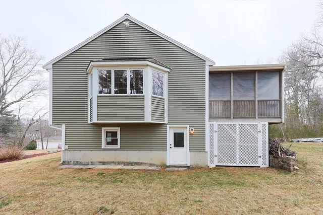 a view of a yard with plants and trees