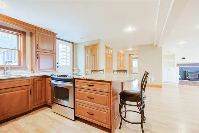 a kitchen with stainless steel appliances granite countertop a stove a sink and a refrigerator