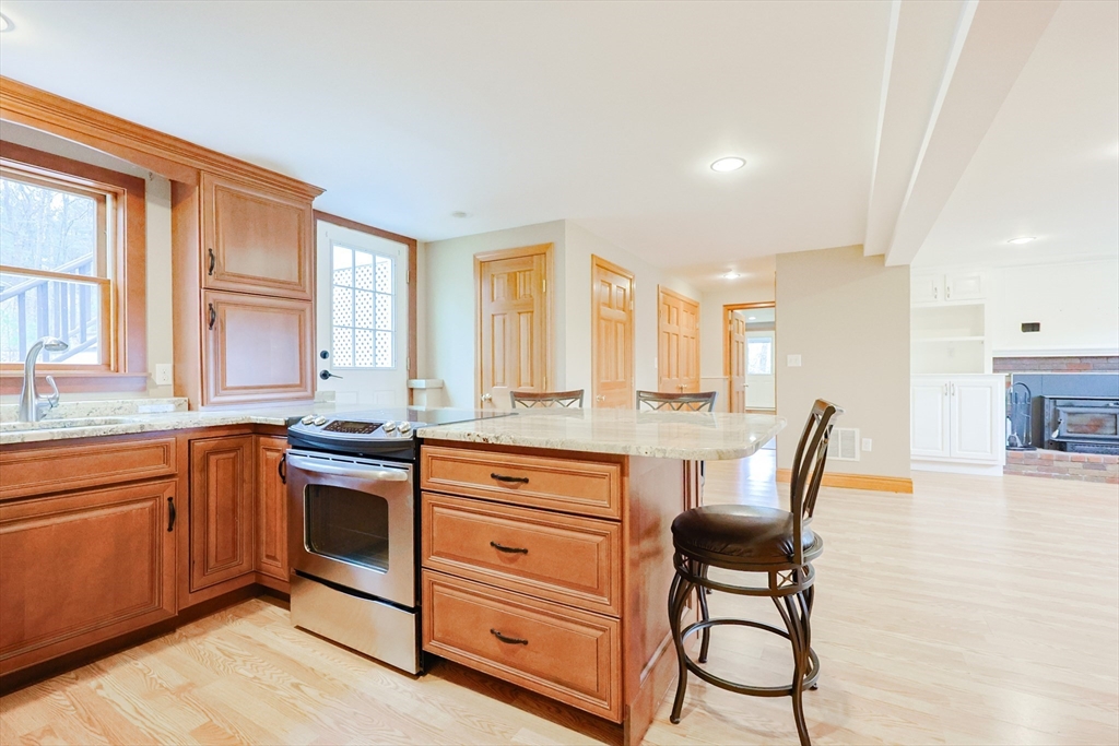 68 Greene Street, Unit A Hopedale, MA 01747 - Photo 4 of 26 a kitchen with stainless steel appliances granite countertop a stove a sink and a refrigerator