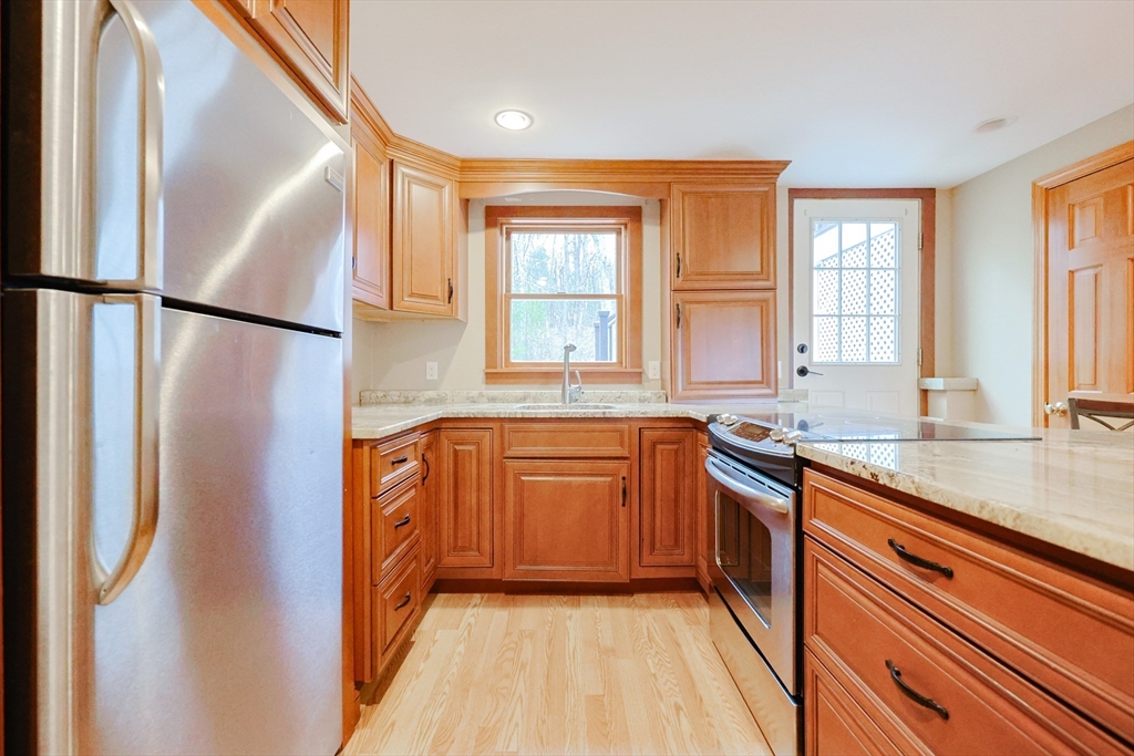 68 Greene Street, Unit A Hopedale, MA 01747 - Photo 5 of 26 a kitchen with stainless steel appliances granite countertop a refrigerator and a sink