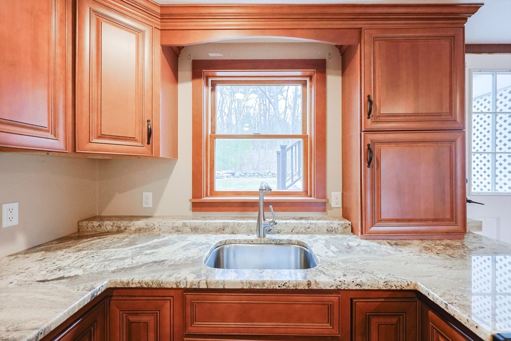 68 Greene Street, Unit A Hopedale, MA 01747 - Photo 6 of 26 a kitchen with granite countertop a sink and a window