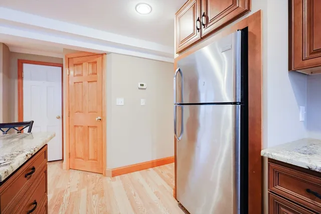 a view of a kitchen with a sink and a refrigerator