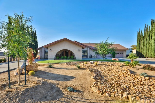 12475 Reata Road Apple Valley, CA 92308 - Photo 1 of 1 a front view of a house with a yard