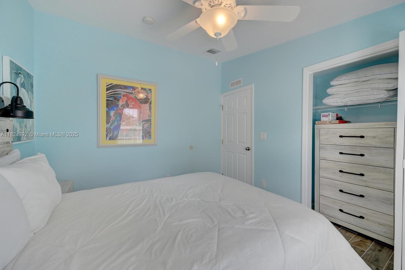 239 Lower Matecumbe Road Key Largo, FL 33037 - Photo 36 of 70 a bedroom with a bed and a dresser