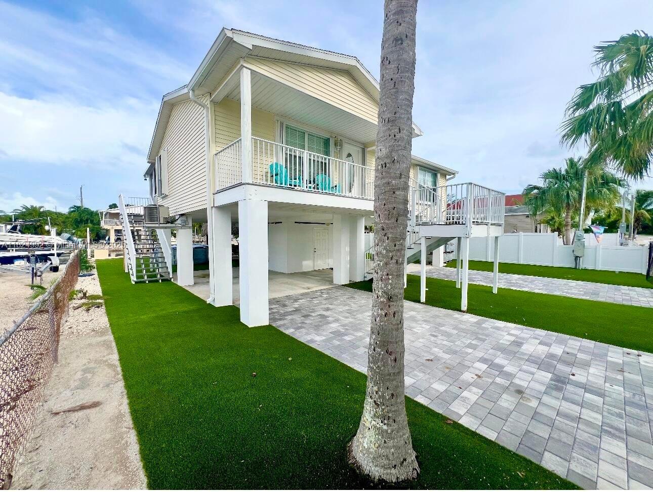 239 Lower Matecumbe Road Key Largo, FL 33037 - Photo 43 of 70 a view of a house with a yard