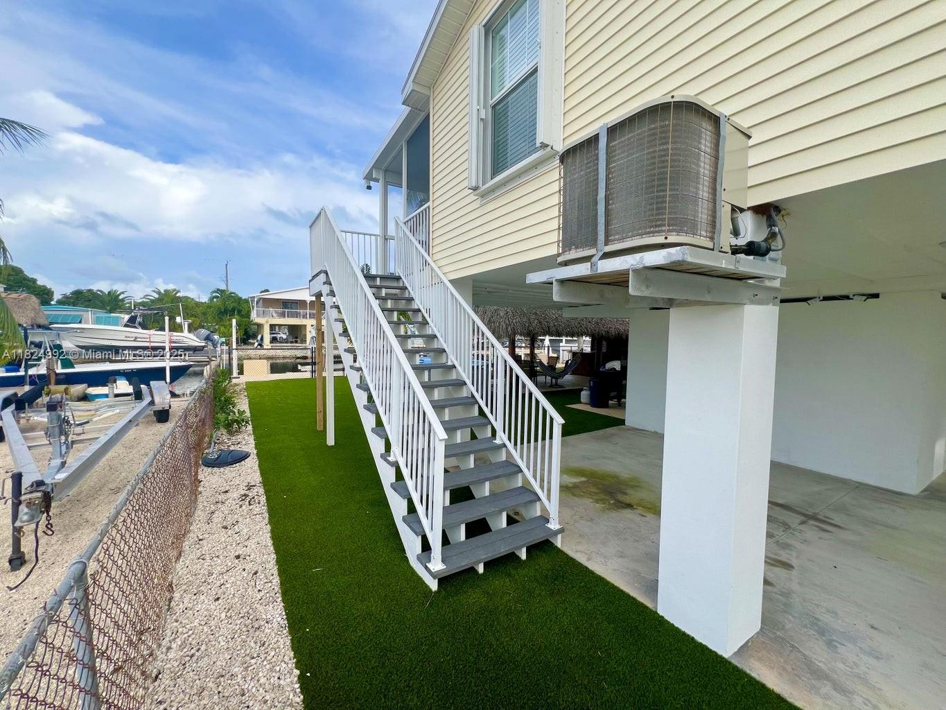 239 Lower Matecumbe Road Key Largo, FL 33037 - Photo 44 of 70 a view of a house with a yard