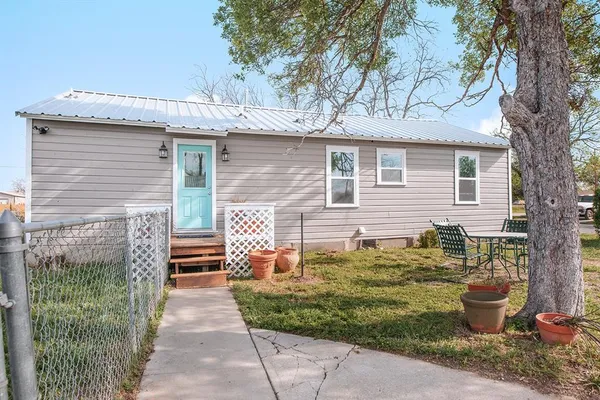 a backyard of a house with outdoor seating