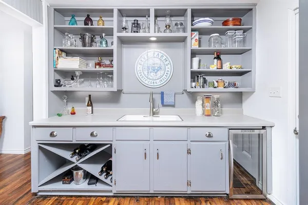 a living room with cabinets and book shelf